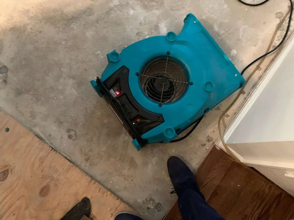 Air mover drying subfloor during Leak Detection & Repair in Taos
